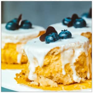 Desserts on a plate with blueberries on top by Brina Blum on Unsplash