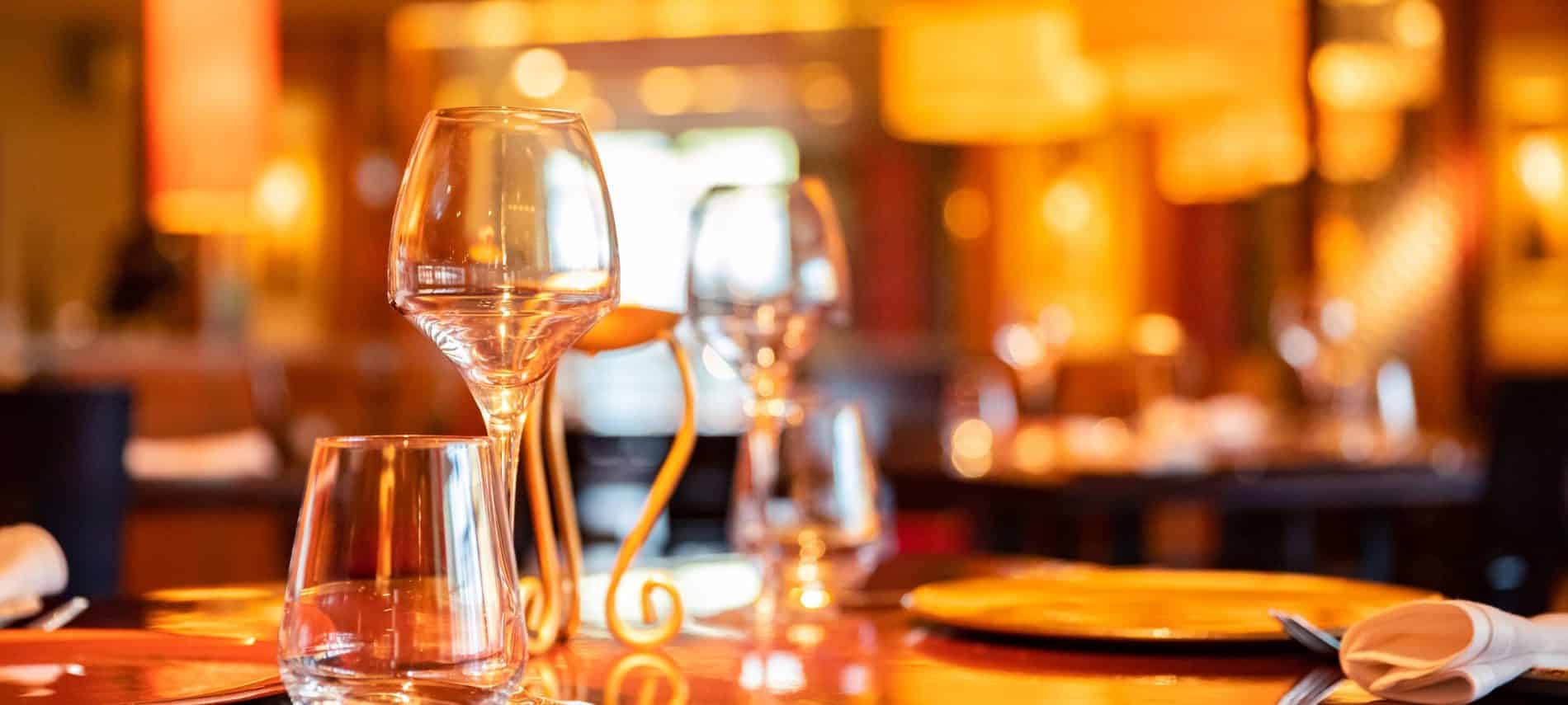 Table setting at a fine dining restaurant with golden lighting