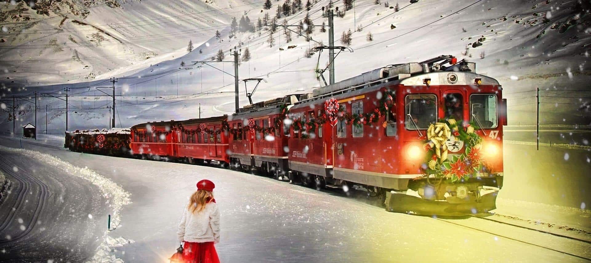a red holiday train moving across snow-covered tracks while a little girl holds a lantern, waiting for it