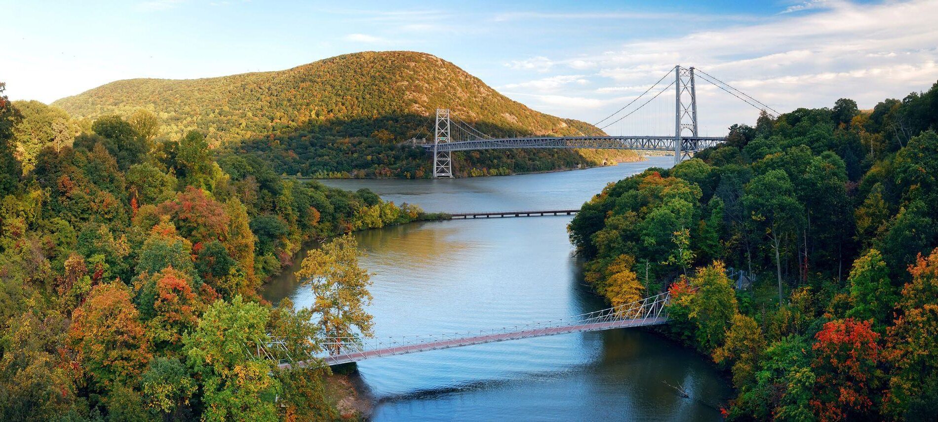 aerial view of hudson valley river and bridges during early fall with a few trees changing colors